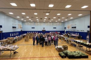 volunteers from food pantry stand in gym
