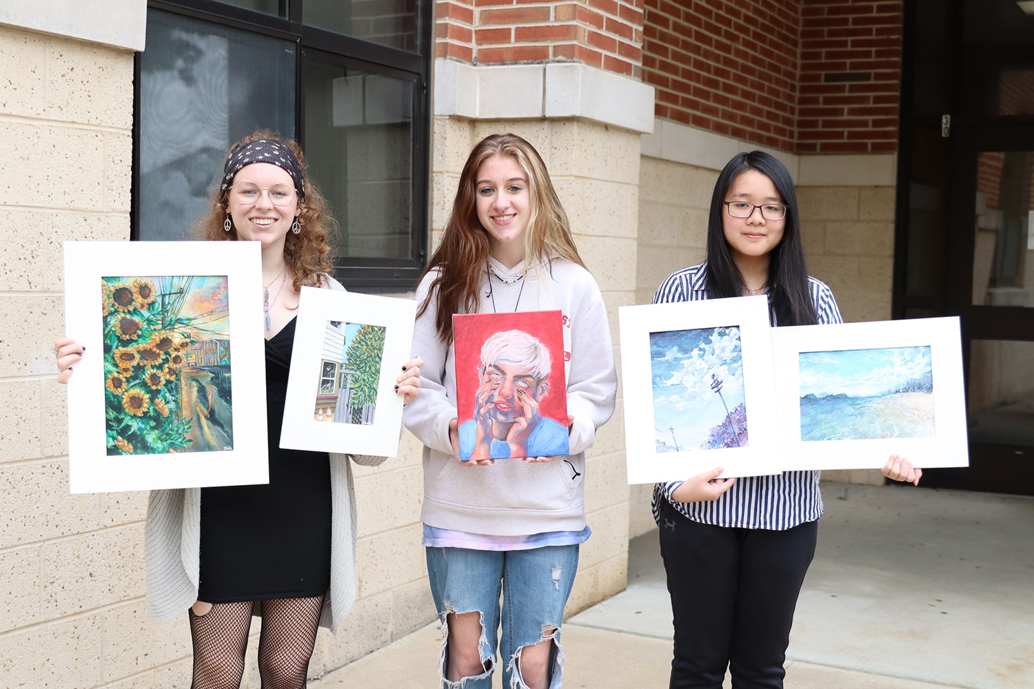 photo of students holding art