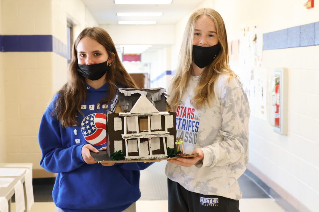 photo of students with handmade haunted houses