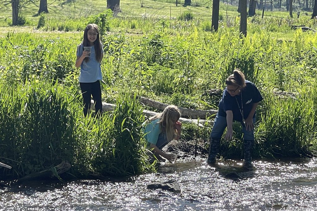 exeter's sandy groff releases trout in the classroom