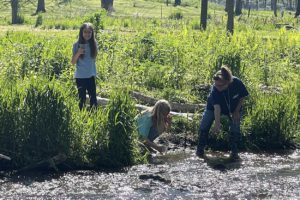 exeter's sandy groff releases trout in the classroom