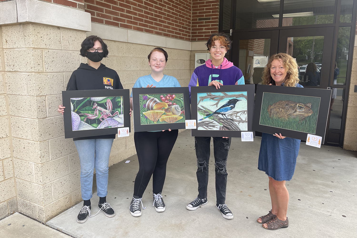 exeter students pose with their nolde forest artwork