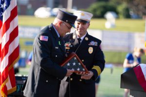 firefighter receives flag
