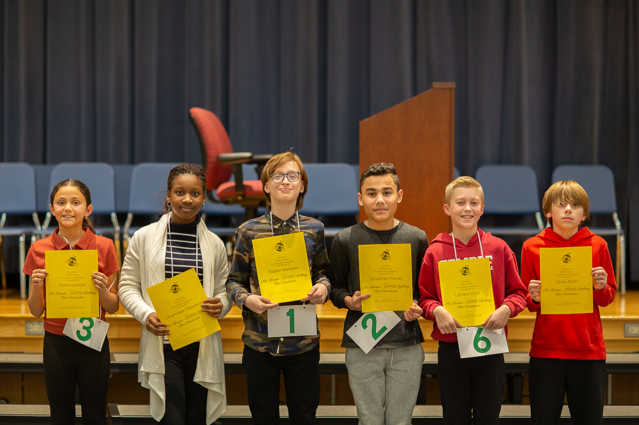 spelling bee winners hold their certificates