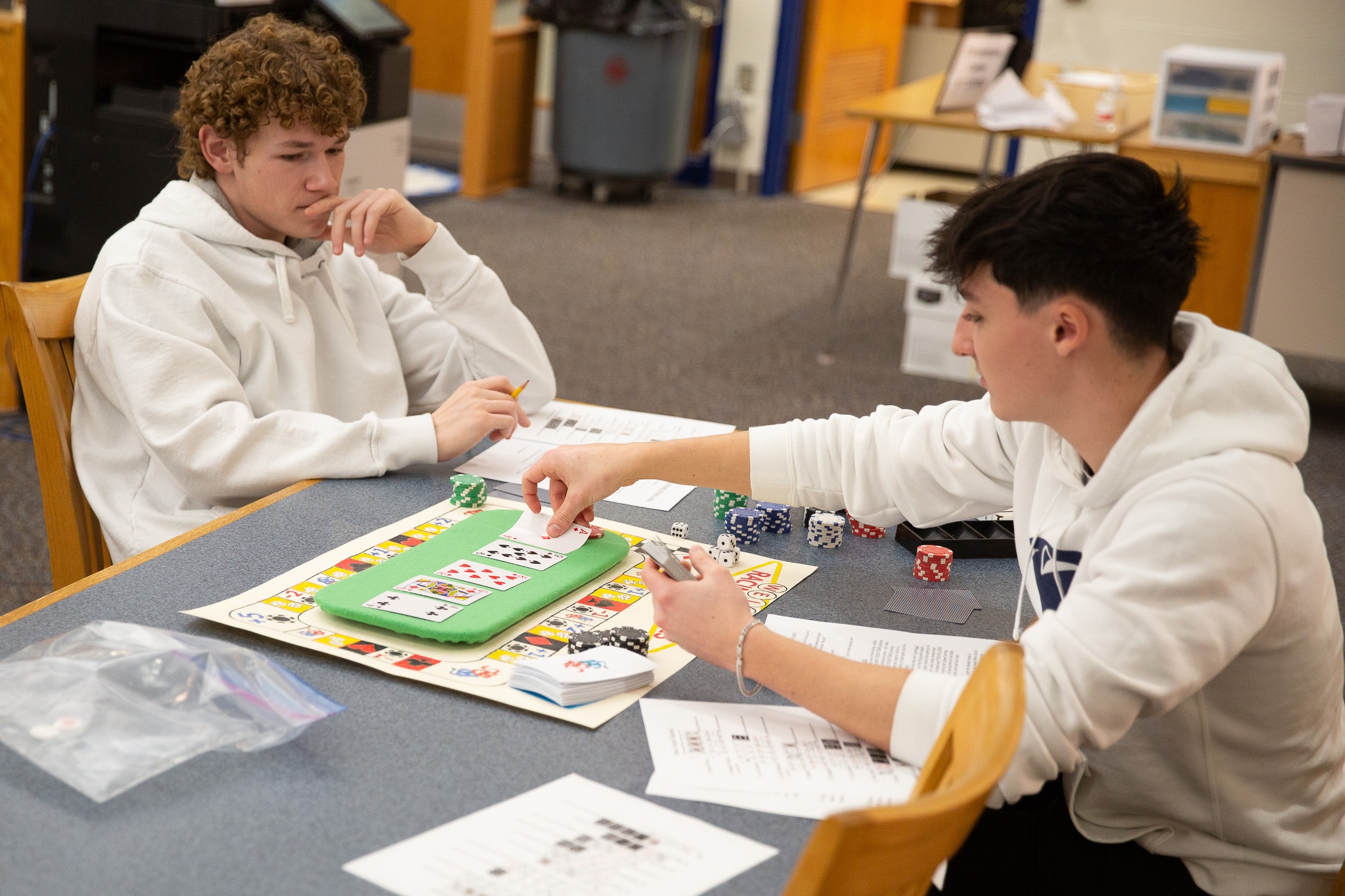 student play and discuss strategies over a board game