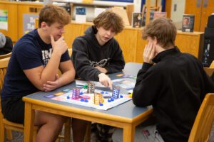 student play and discuss strategies over a board game