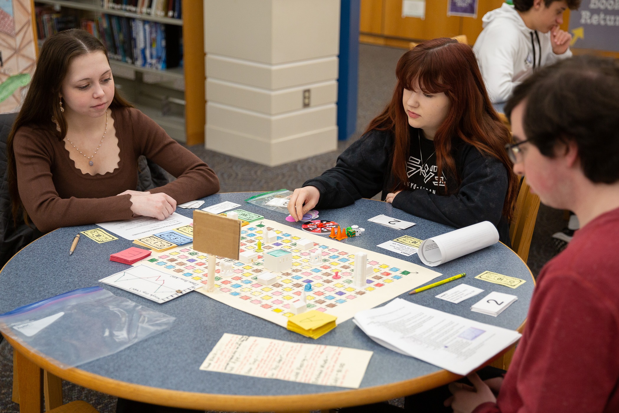 student play and discuss strategies over a board game