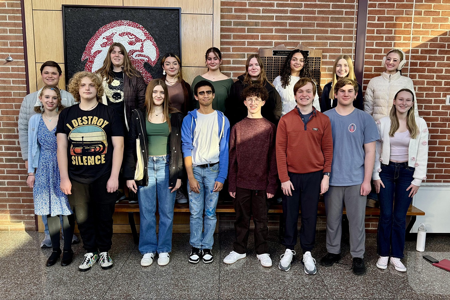 a group of students stand in a hallway