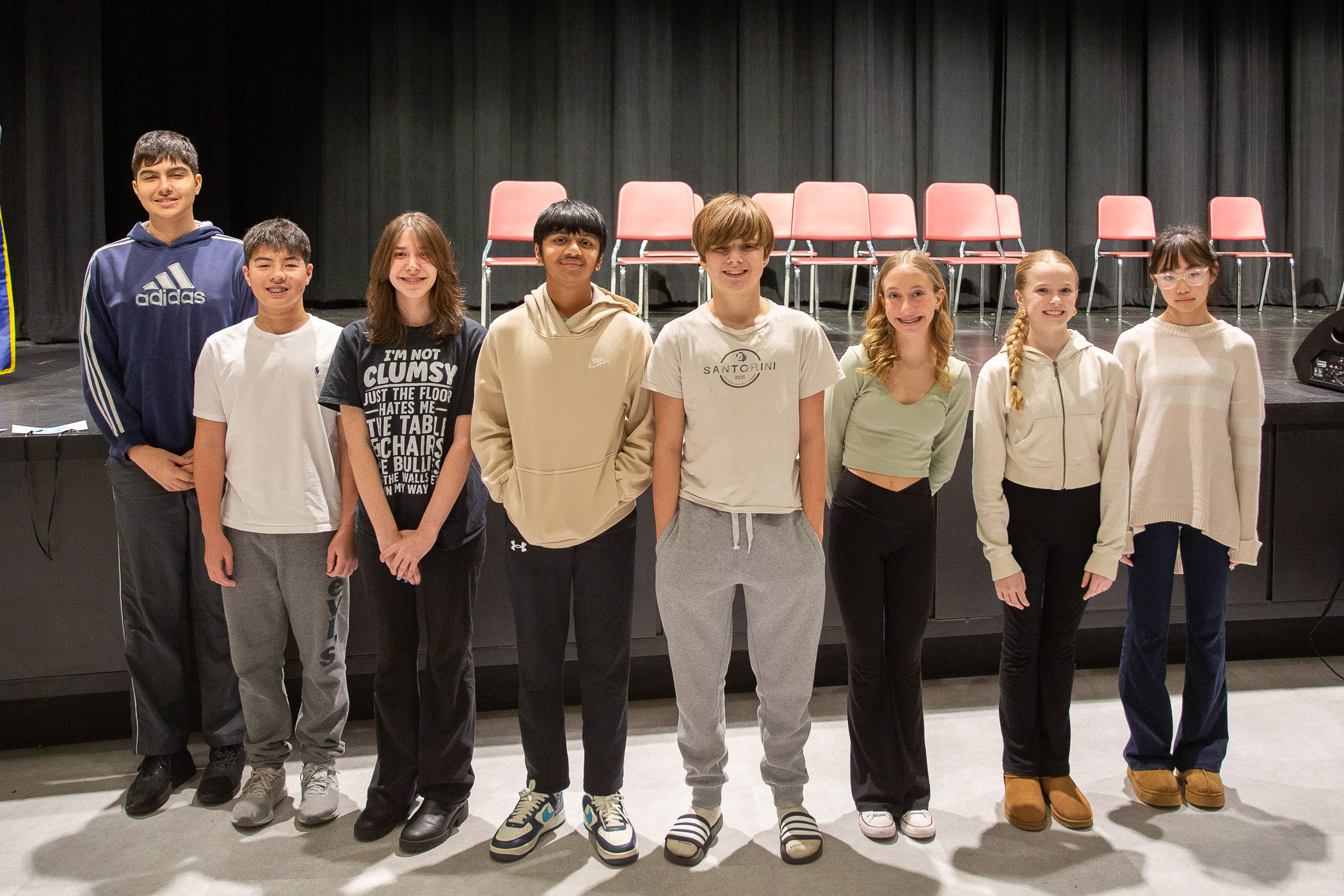 spelling bee students line up to compete in school auditorium