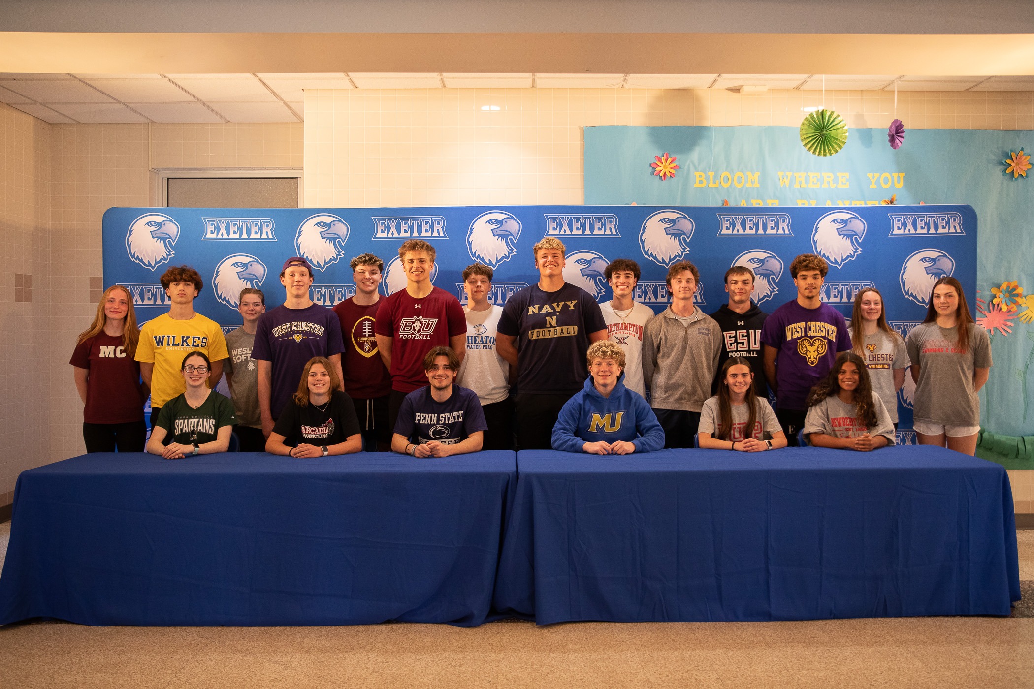 1R2A9514-2 22 student athletes stand in front of a backdrop
